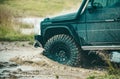 Off-road Jeep car on bad gravel road. Mud and water splash in offroad racing. Off-road travel on mountain road. Royalty Free Stock Photo