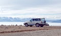 Off-road jeep on the shore of Manasarovar lake, Tibet Royalty Free Stock Photo