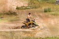 Off road on quad bike rally over mud puddle Royalty Free Stock Photo