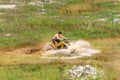 Off road on quad bike rally over mud puddle Royalty Free Stock Photo