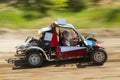 Off-road racing car driving at high speed on a dirt road with a smeared background. The concept of extrieme offroad