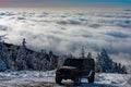 Off-road travel on snow mountain road. Winter ravel concept with 4x4 car. Jeep offroad outdoors adventures.