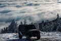 Off-road travel on snow mountain road. Winter ravel concept with 4x4 car. Jeep offroad outdoors adventures.