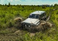 Off-road vehicle brand Nissan Patrol overcomes a pit of mud Royalty Free Stock Photo