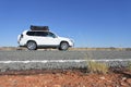An off road vehicle driving on Stuart Highway in Central Australia