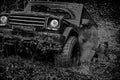 Off-road vehicle goes on the mountain. Tracks on a muddy field. Road adventure. Adventure travel. Bottom view to big Royalty Free Stock Photo