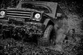 Off-road vehicle goes on the mountain. Tracks on a muddy field. Road adventure. Adventure travel. Bottom view to big Royalty Free Stock Photo