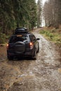 Off-road vehicle goes on the mountain way during the rainy season Royalty Free Stock Photo