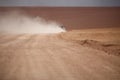 An off road vehicle running in the dusty of desert. Adventure in Bolivia highlands in the Andes. Royalty Free Stock Photo