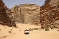 Off-road vehicle for safaris rides through the Red Mountains of the canyon of Wadi Rum desert in Jordan. Wadi Rum also known as Royalty Free Stock Photo