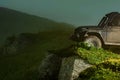 Off-road vehicle stuck on impenetrable road after rain in the countryside. Offroad travel on mountain road. Mud and Royalty Free Stock Photo