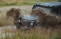 Off-road vehicle stuck on impenetrable road after rain in the countryside. Travel and racing concept for 4x4 drive off Royalty Free Stock Photo