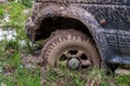 Off-road vehicle stuck in the mud. Dirty offroad car in swamp. Adventure travel concept. 4x4 SUV got bogged. Journey, tourism Royalty Free Stock Photo