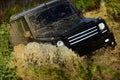 Off road vehicle or SUV crossing puddle with dirt splash. Competition, energy and motorsport concept. Car racing in Royalty Free Stock Photo