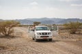 Off-road vehicle and tourists on the Jebel Shams mountains Oman