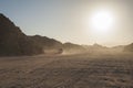 Off road vehicle traveling through arid desert landscape Royalty Free Stock Photo