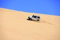 Off-road vehicle traveling in the desert Royalty Free Stock Photo