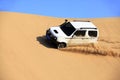 Off-road vehicle traveling in the desert Royalty Free Stock Photo