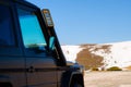 Off road 4x4 car in the snowy mountains on a sunny day. Off-road traveling, all terrain vehicle in nature Royalty Free Stock Photo