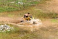 Off road on 4x4 quad bike through mud puddle Royalty Free Stock Photo