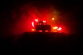 Off roader jeep silhouette on dark toned foggy sky background. Car with light at night