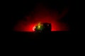 Off roader jeep silhouette on dark toned foggy sky background. Car with light at night