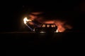 Off roader jeep silhouette on dark toned foggy sky background. Car with light at night