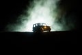 Off roader jeep silhouette on dark toned foggy sky background. Car with light at night.