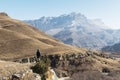 The off-season landscape of the mountains of the Caucasus on a sunny day. a man on the edge of a cliff looking out into Royalty Free Stock Photo