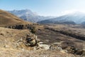 The off-season landscape of the mountains of the Caucasus on a sunny day. a man on the edge of a cliff looking out into Royalty Free Stock Photo