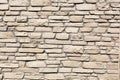 Off white brick stone wall, different size bricks