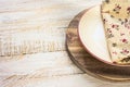 Off-white empty plate with red board on round cutting board, linen floral napkin Royalty Free Stock Photo