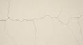 Off-white wall with visible cracks forming irregular patterns. The texture is rough, and the cracks Royalty Free Stock Photo