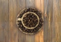 ÃÂ¡offee beans and a cup on a wooden background. Coffe cup with copy space for text. Royalty Free Stock Photo