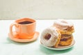 ÃÂ¡offee break. Orange cup with coffee and a plate from donats Royalty Free Stock Photo