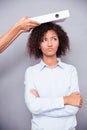 Offended afro american woman stnading with arms folded