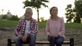 Offended elderly couple sitting on bench and thinking about divorce, relations