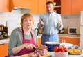 Offended elderly mother while dissatisfied adult son at kitchen