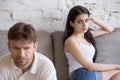 Offended frustrated girlfriend looking at sitting separately boy Royalty Free Stock Photo