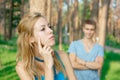 Offended girl with a boy at the background Royalty Free Stock Photo