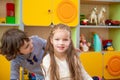 Offended girl tries to console another girl. one little girl looks in the face of another