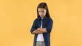 Portrait of sad girl with folded arms standing at studio Royalty Free Stock Photo
