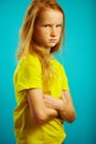 Offended little girl with arms crossed at the chest, angry or resentful, expresses a bad and sad mood. Royalty Free Stock Photo