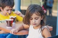 Offended little girl in a cafe with her brother Royalty Free Stock Photo