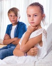 Offended little girl and teenager indoors Royalty Free Stock Photo