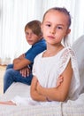 Offended little girl and teenager indoors Royalty Free Stock Photo