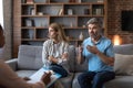 Offended mature caucasian woman ignores man with beard at meeting with psychologist