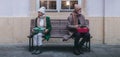 Offended senior couple citting on city bench.