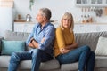 Offended Senior Couple Sitting Back-To-Back Having Marital Crisis At Home Royalty Free Stock Photo