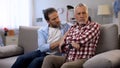 Offended senior male ignoring middle-aged son, quarrelling and misunderstanding